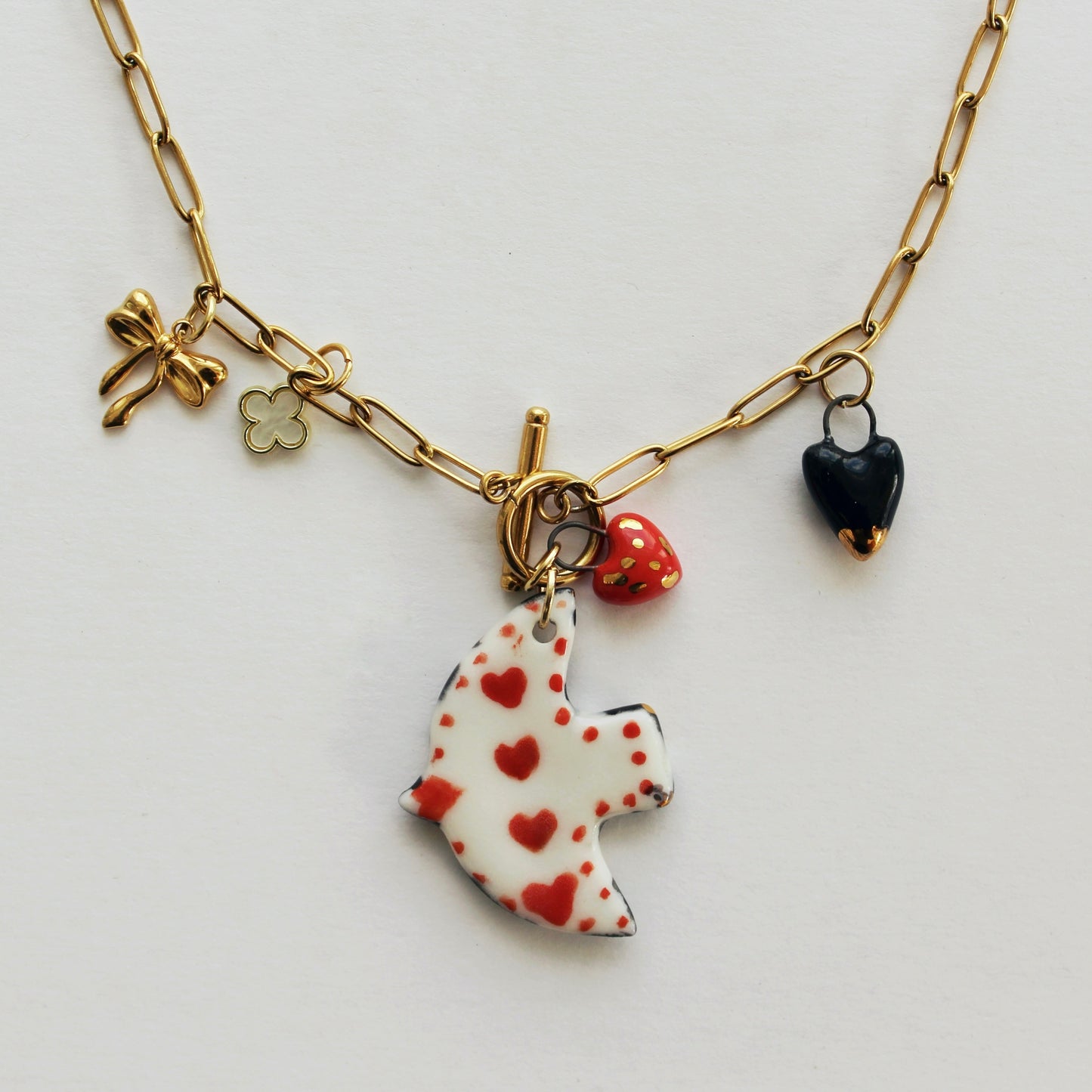 Collier oiseau réversible en porcelaine + breloques variées